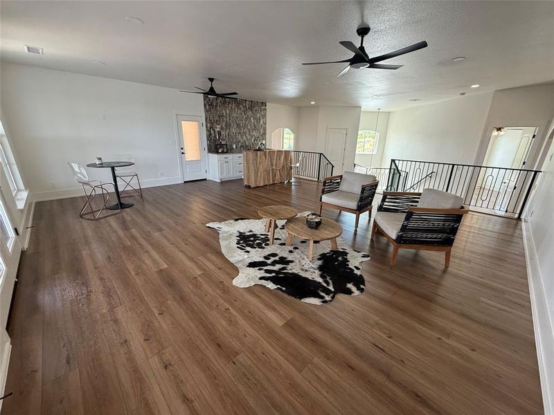 Living room with ceiling fan and wood finished floors Living room with ceiling fan and wood finished floors