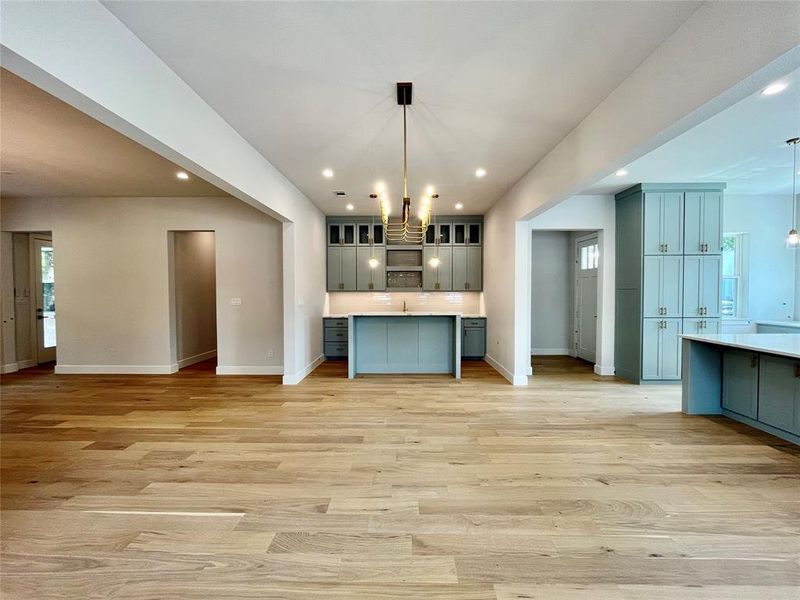 Kitchen featuring a notable chandelier, hanging light fixtures, and light hardwood / wood-style floors