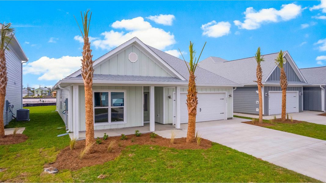Front exterior of a new home in WindMark Beach, Port Saint Joe, FL, highlighting curb appeal (Image 16). Front exterior of a new home in WindMark Beach, Port Saint Joe, FL, highlighting curb appeal (Image 16).