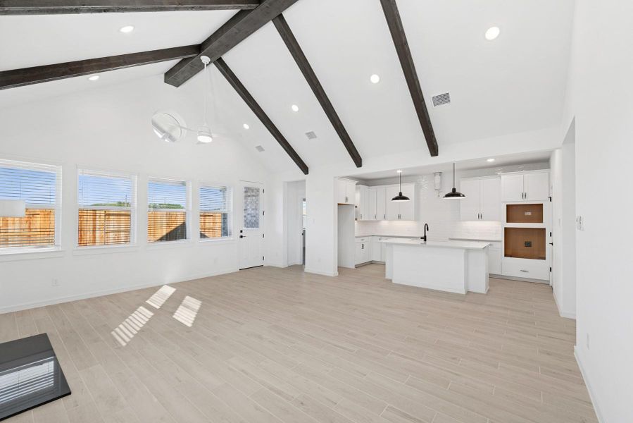 Bright and airy living area with vaulted ceilings and stained beams
