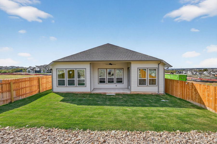 Rear view of property featuring a patio area, ceiling fan, a fenced backyard, and roof with shingles Rear view of property featuring a patio area, ceiling fan, a fenced backyard, and roof with shingles