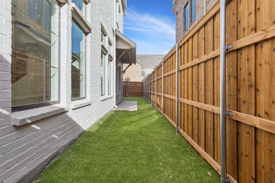 Exterior details and patio area of a home in Newman Village Townhomes, Frisco (Image 2). Exterior details and patio area of a home in Newman Village Townhomes, Frisco (Image 2).