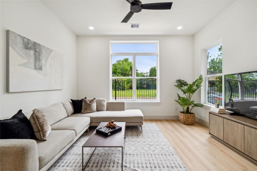 Enjoy natural serenity through oversized windows that frame green space views and flood the living room with soft, all-day light.