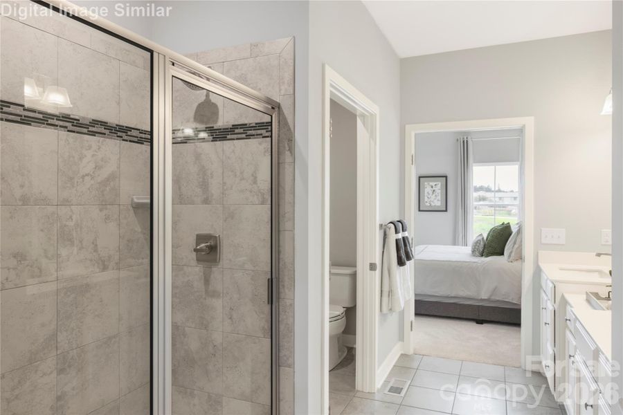 Indulge in everyday luxury with a spa-like primary bath featuring a sleek walk-in shower, private water closet, and elegant tiled floors that flow seamlessly into your bedroom retreat. It’s a sanctuary of style and serenity—where comfort meets sophistication in every detail.