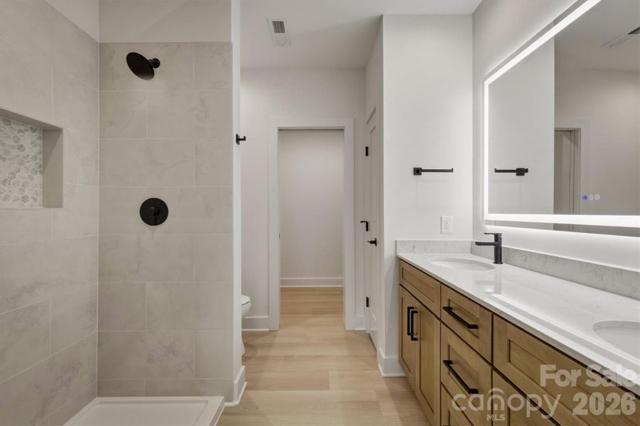 Here is the fourth bathroom through that barn door. It features a dual sink, a lighted anti fog mirror, and a glass shower enclosure (not installed yet but coming). Here is the fourth bathroom through that barn door. It features a dual sink, a lighted anti fog mirror, and a glass shower enclosure (not installed yet but coming).