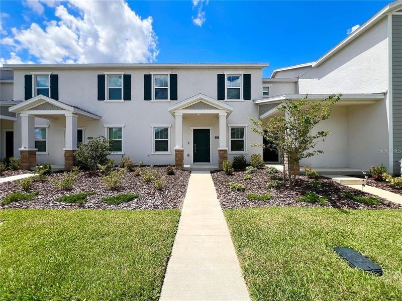 Front exterior of a new home in , Clermont, FL, highlighting curb appeal (Image 27).