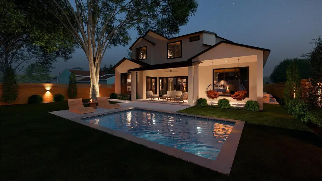 An inviting pool and patio area complement this residence, illuminated for evening enjoyment.