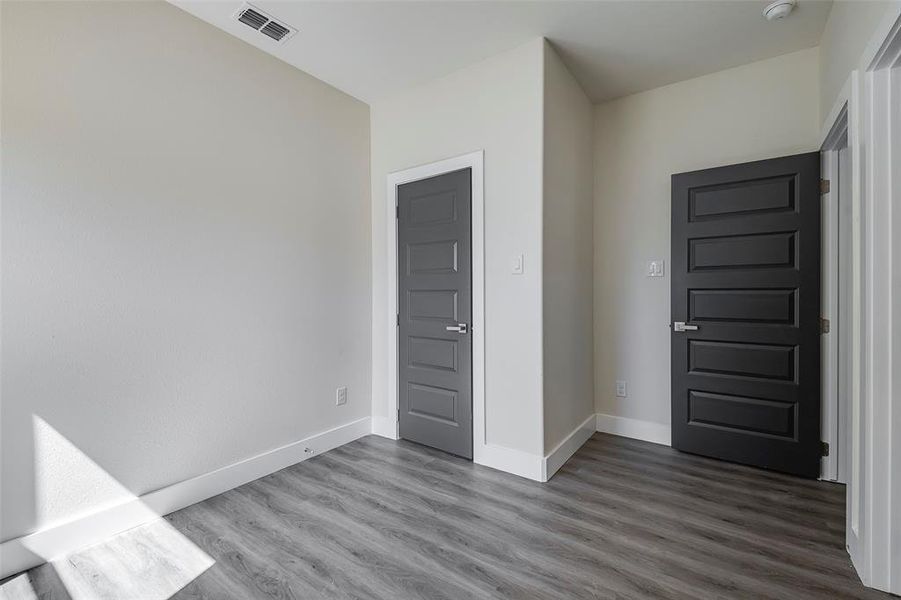 Unfurnished bedroom featuring hardwood / wood-style floors