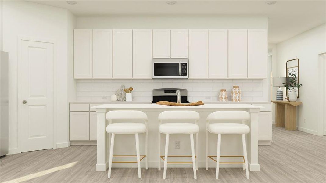 Kitchen with white cabinets, a center island, light wood-type flooring, and stainless steel appliances