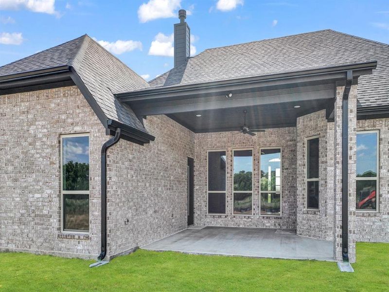 Rear view of house featuring a patio area and brick siding Rear view of house featuring a patio area and brick siding