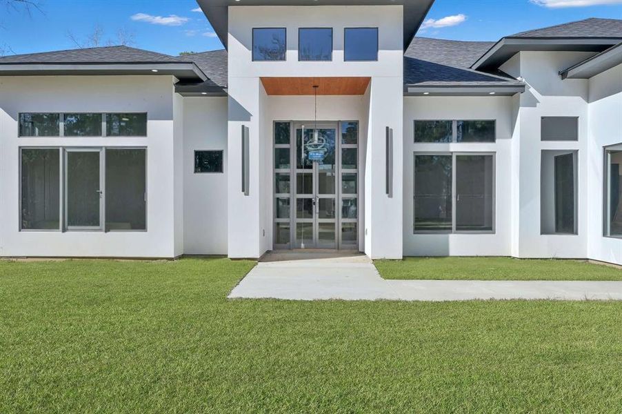 Grand entrance featuring a striking 12-foot glass door.