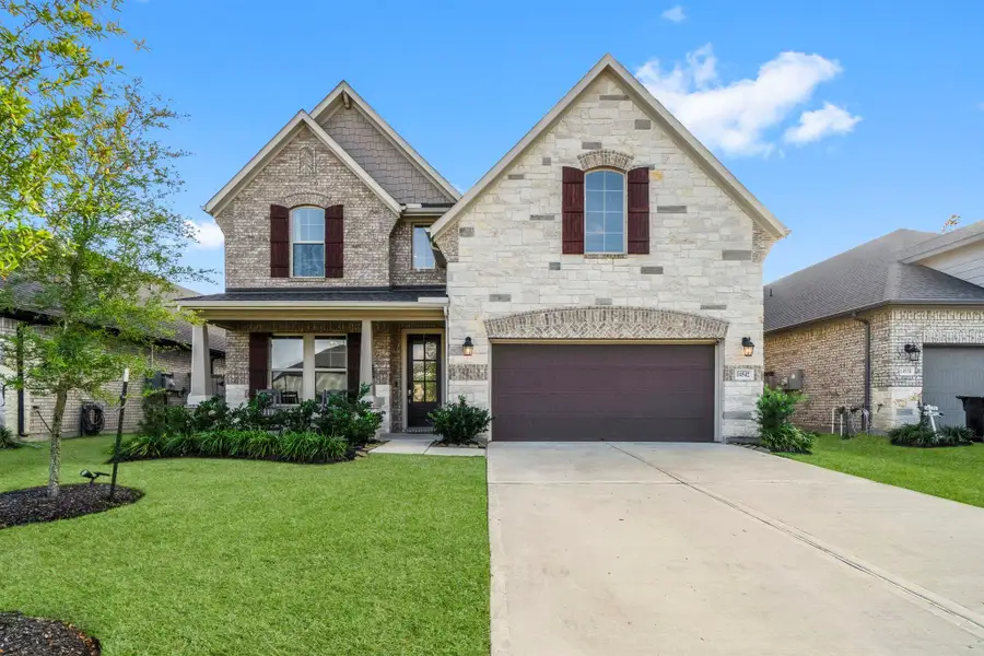 Welcome home! Beautiful brick & stone exterior and very well maintained flower beds greet you.