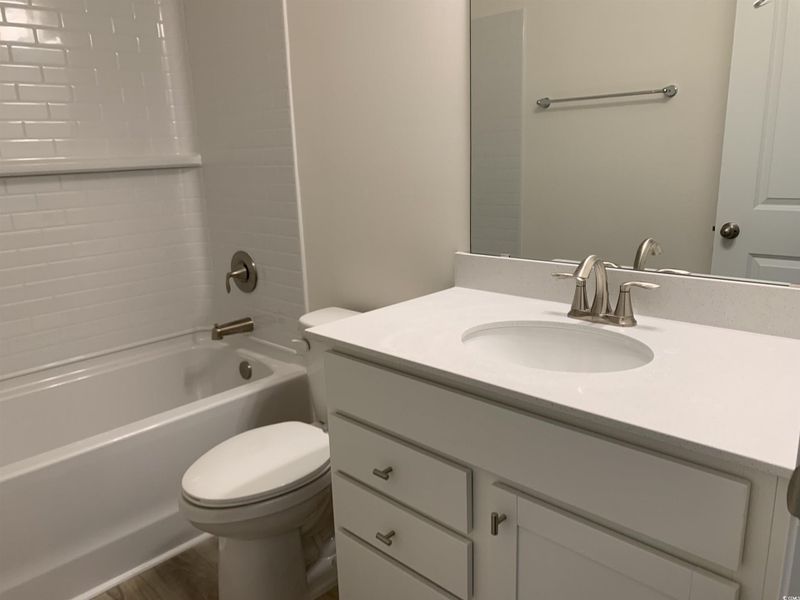 Full bathroom featuring shower / bath combination and vanity