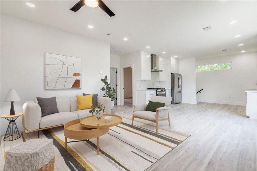 VS Living room featuring light wood finished floors, ceiling fan, and recessed lighting