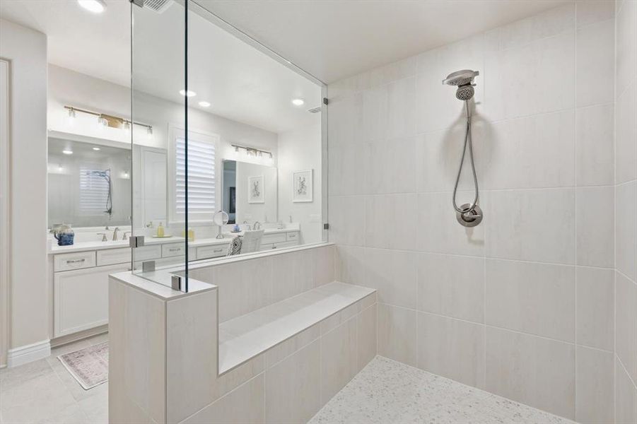 Full bathroom featuring vanity, recessed lighting, and tiled shower