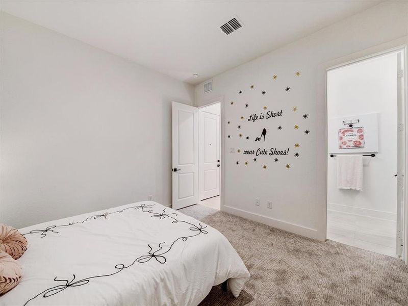 Bedroom featuring light carpet and connected bathroom Bedroom featuring light carpet and connected bathroom
