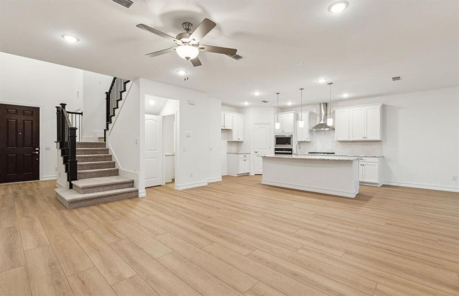 Open concept gathering room creating a spacious and inviting atmosphere *Real home pictured