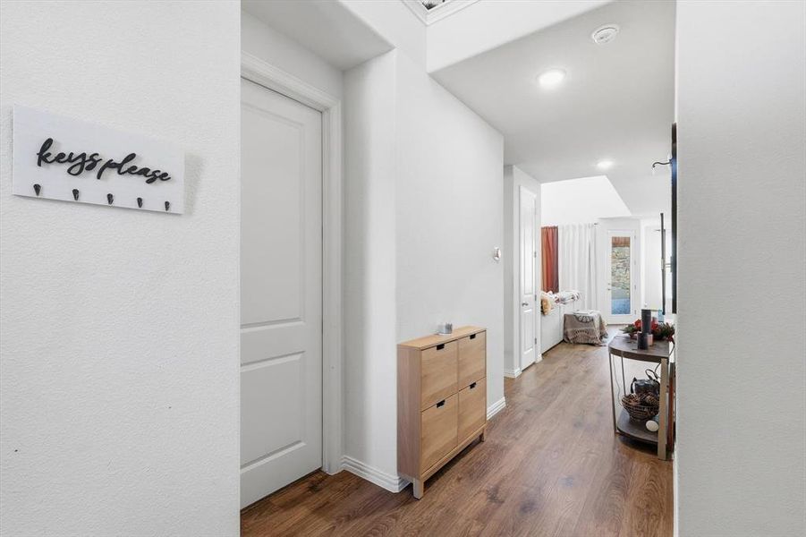 Hallway with dark wood-style flooring and recessed lighting