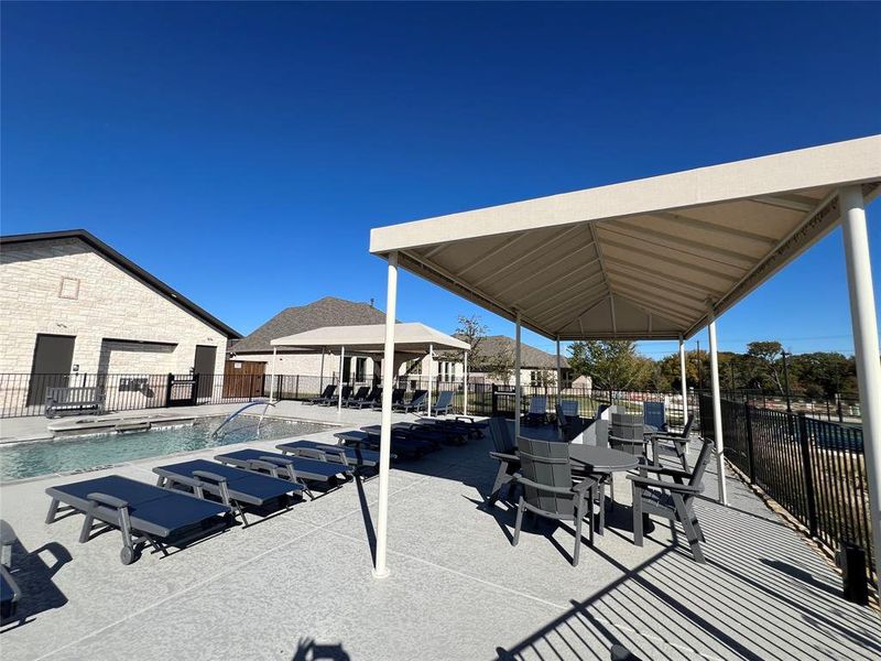 View of community patio with a refreshing pool and patio area.