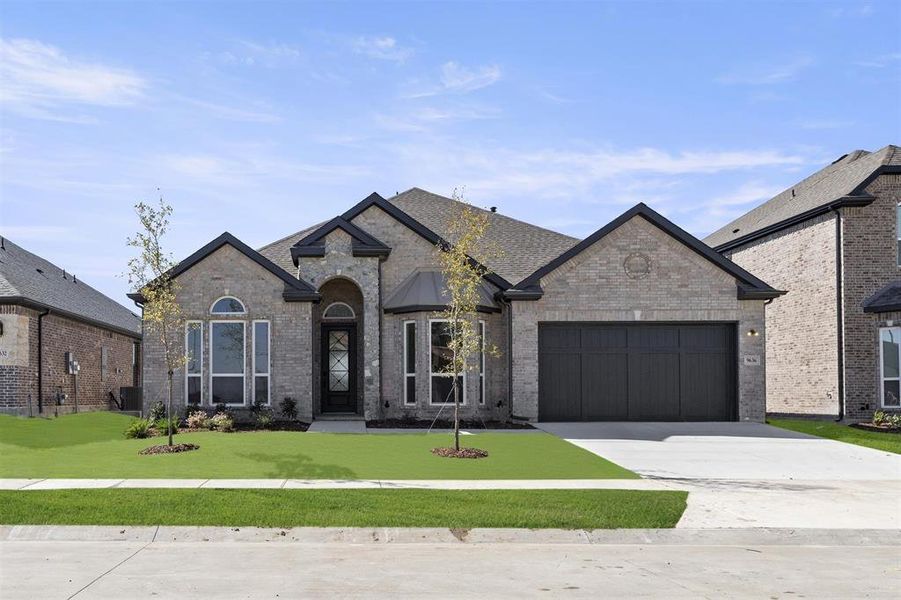 Front exterior of a new home in Polo Ridge, Mesquite, TX, highlighting curb appeal (Image 22). Front exterior of a new home in Polo Ridge, Mesquite, TX, highlighting curb appeal (Image 22).