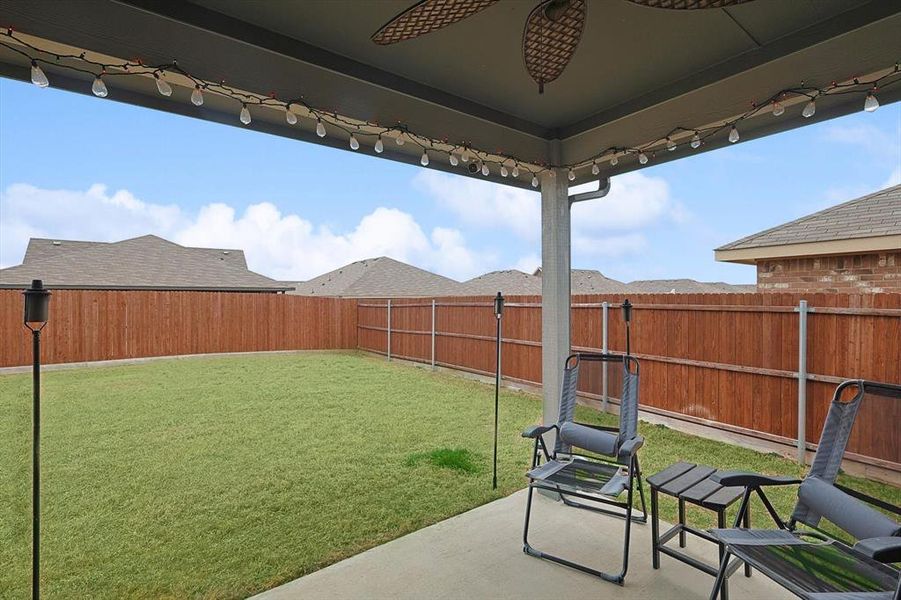 View of yard with a patio area, a fenced backyard, and a ceiling fan