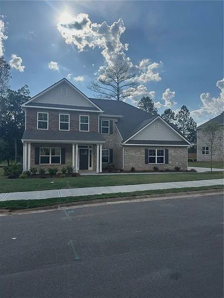 Front exterior of a new home in Mirror Lake at South Harbour, Villa Rica, GA, highlighting curb appeal (Image 1).