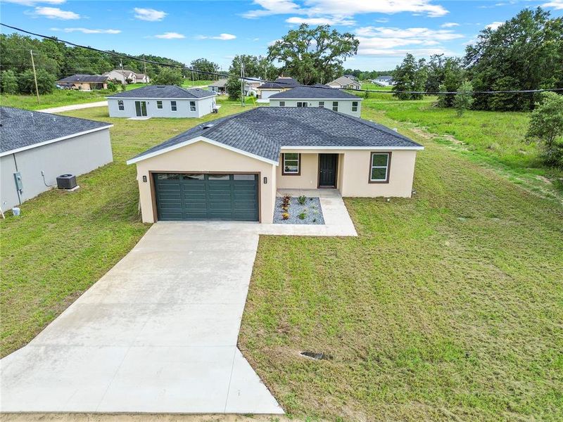 Front exterior of a new home in , Dunnellon, FL, highlighting curb appeal (Image 2).