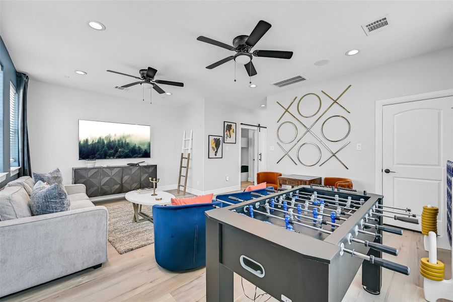 Oversized windows and elevated ceilings make this second living area feel bright and expansive. It’s the perfect bonus space for entertaining or unwinding.