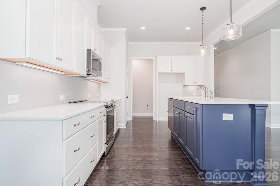 "Chef's" kitchen with an amazing island with pendant lights. "Chef's" kitchen with an amazing island with pendant lights.