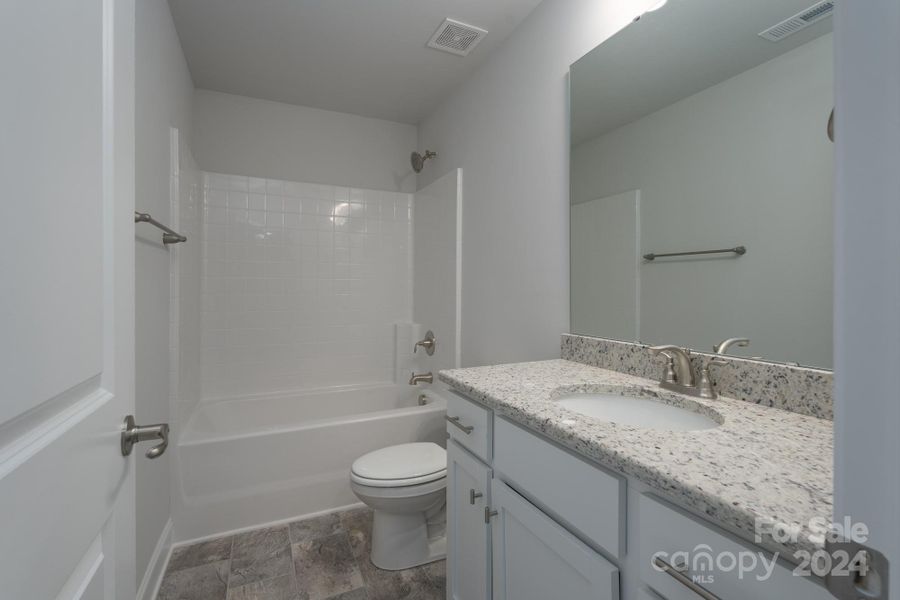 Upstairs second bath. Photo representation. Colors and options will differ.