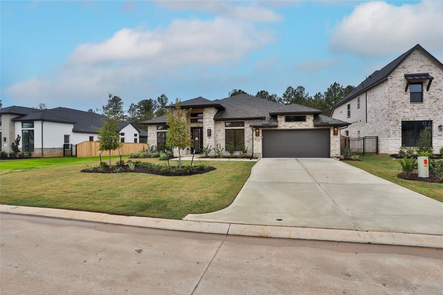 Front exterior of a new home in Kresston 65', Magnolia, TX, highlighting curb appeal (Image 1).