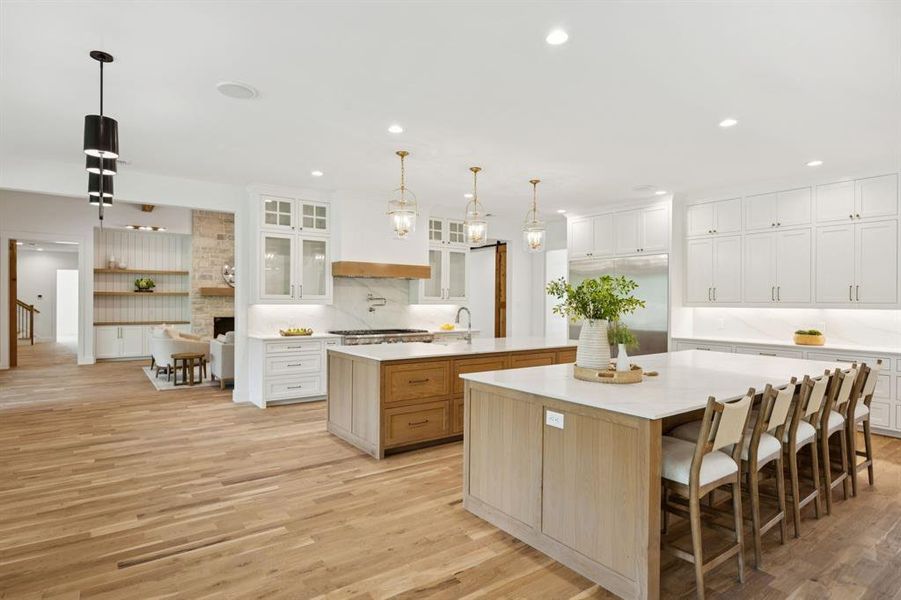 Ceiling-height cabinetry, glass doors and impressive range hood. Ceiling-height cabinetry, glass doors and impressive range hood.