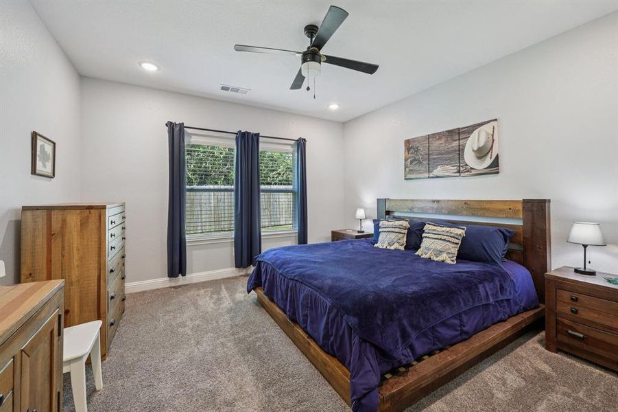 Bedroom with carpet flooring, a ceiling fan, and recessed lighting Bedroom with carpet flooring, a ceiling fan, and recessed lighting