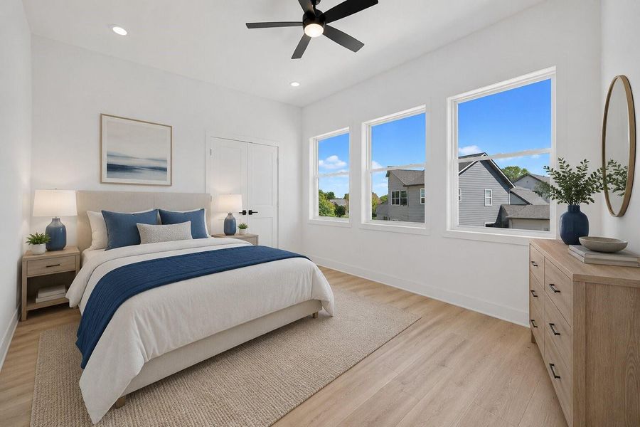 Airy bedroom retreat featuring soaring ceilings, oversized windows and a bright modern aesthetic
