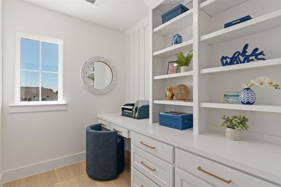 Office space with built in study area and light wood-style flooring Office space with built in study area and light wood-style flooring