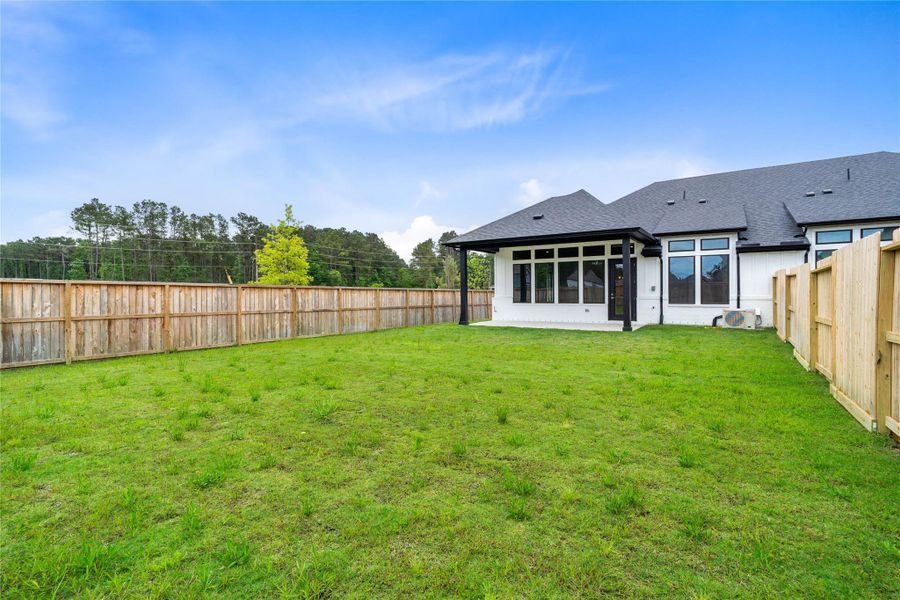 The backyard green space is fully fenced for added privacy.