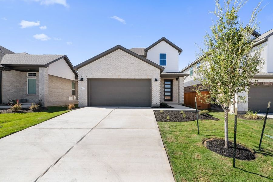 Front exterior of a new home in Terrace Collection at Lariat, Liberty Hill, TX, highlighting curb appeal (Image 1). Front exterior of a new home in Terrace Collection at Lariat, Liberty Hill, TX, highlighting curb appeal (Image 1).