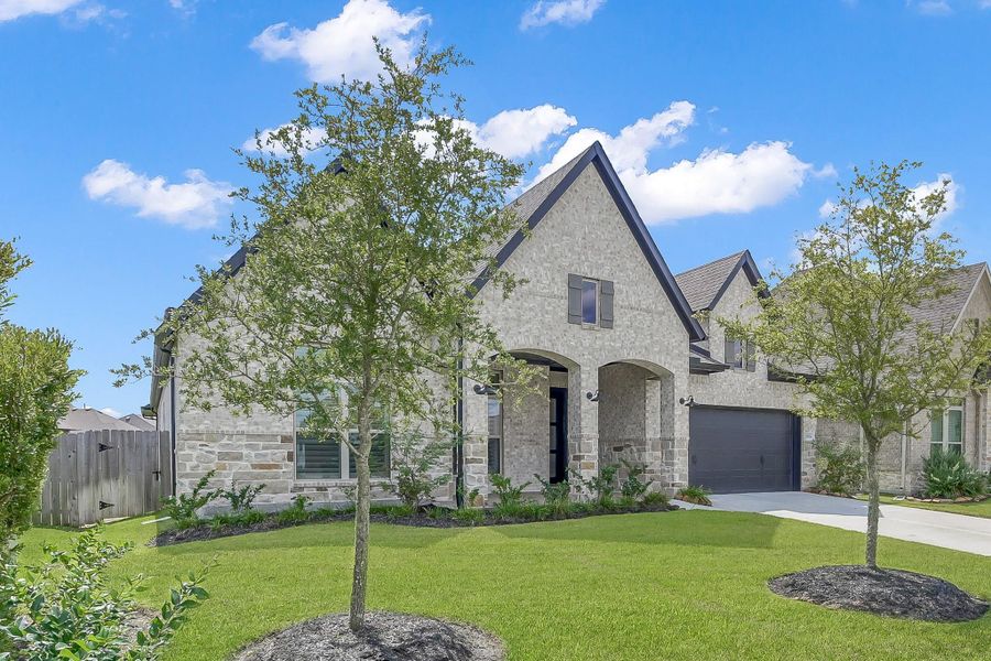 Front exterior of a new home in The Meadows at Imperial Oaks, Conroe, TX, highlighting curb appeal (Image 20). Front exterior of a new home in The Meadows at Imperial Oaks, Conroe, TX, highlighting curb appeal (Image 20).