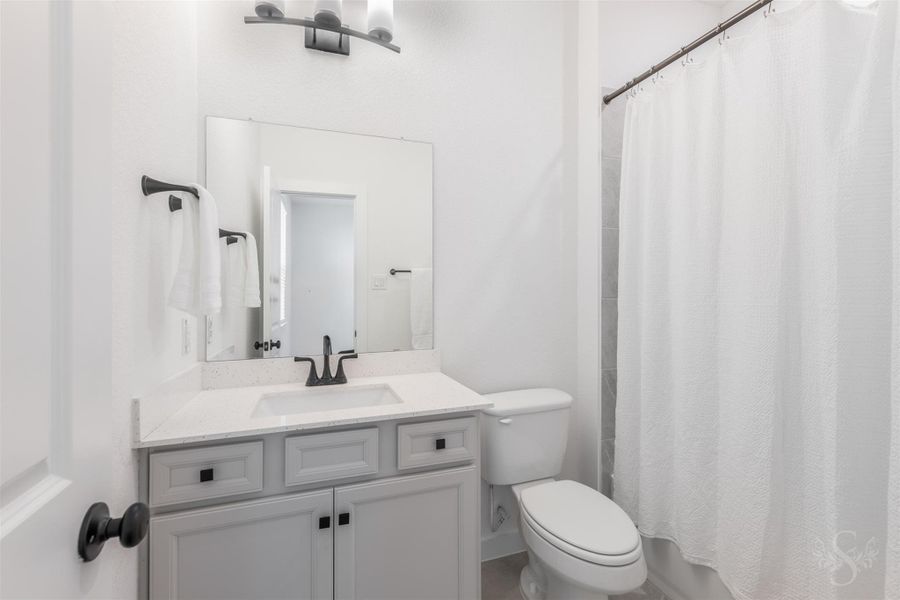 A bright and modern full bath featuring a sleek vanity and matte black fixtures. The tub/shower combo with neutral tile surround offers both style and everyday convenience for guests or family. A bright and modern full bath featuring a sleek vanity and matte black fixtures. The tub/shower combo with neutral tile surround offers both style and everyday convenience for guests or family.
