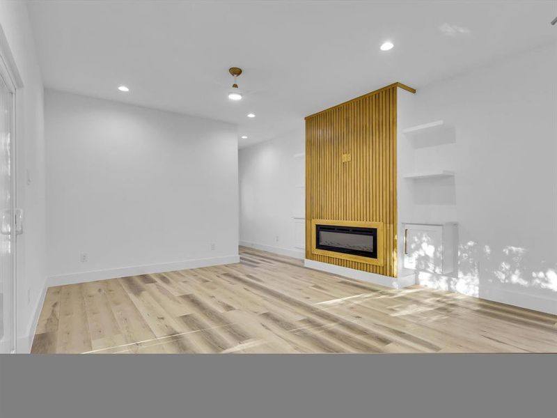 Unfurnished living room featuring hardwood / wood-style flooring