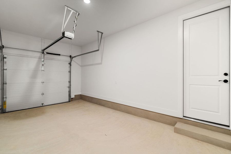 A well-lit garage offers direct access to the interior.