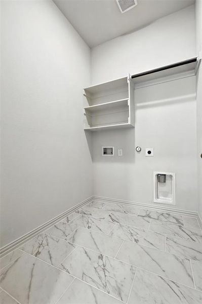 Laundry area featuring electric dryer hookup, hookup for a washing machine, hookup for a gas dryer, and marble finish floors Laundry area featuring electric dryer hookup, hookup for a washing machine, hookup for a gas dryer, and marble finish floors