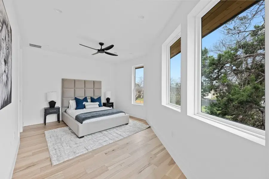 Bedroom with light wood finished floors and ceiling fan