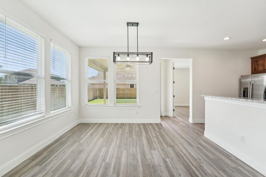 Breakfast area featuring recessed lighting, baseboards, and wood-style vinyl flooring Breakfast area featuring recessed lighting, baseboards, and wood-style vinyl flooring