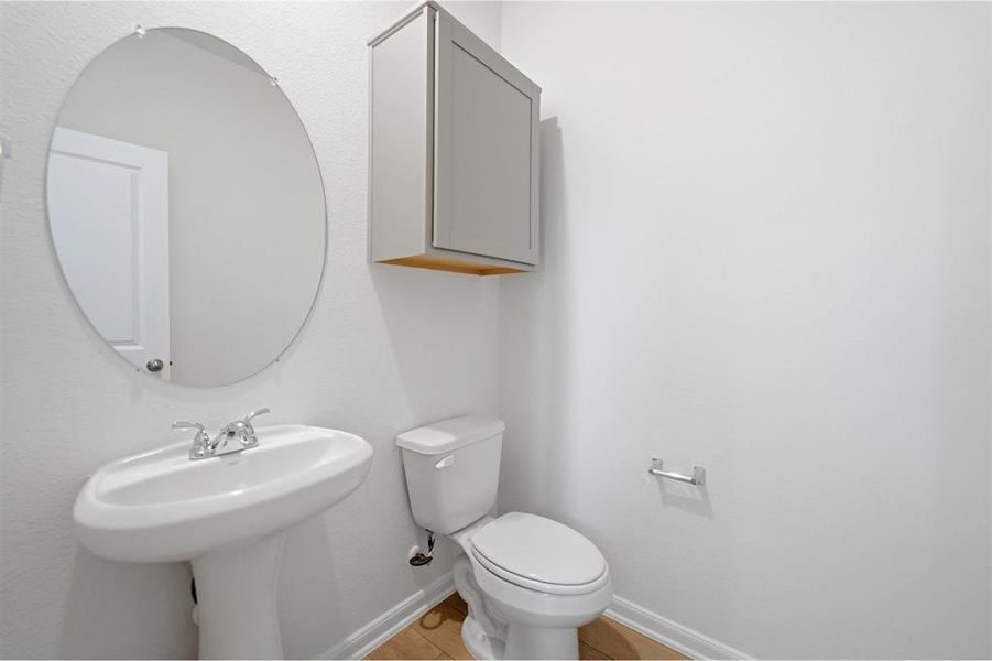 Bathroom with toilet and baseboards