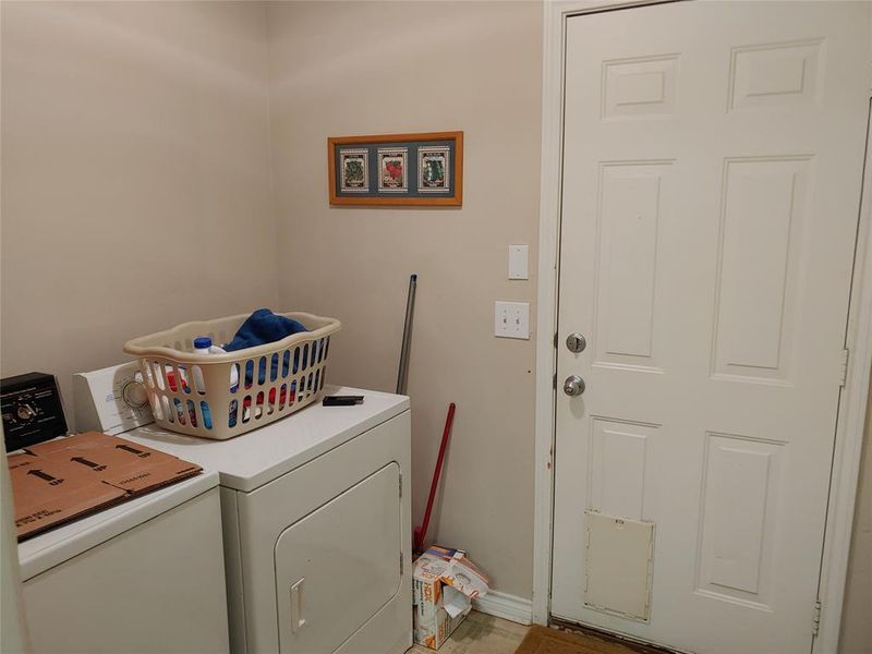 Dedicated laundry area with a white paneled door