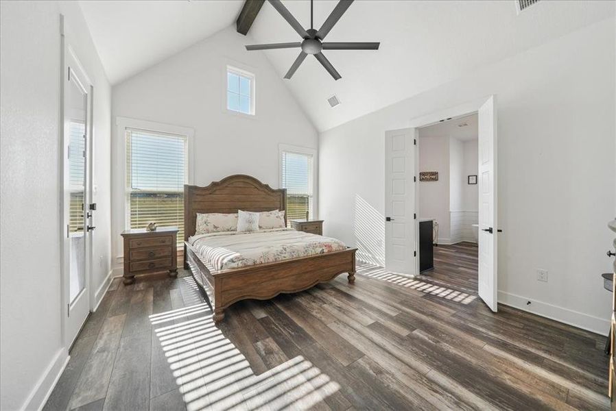 Bedroom featuring high vaulted ceiling, dark wood-style flooring, beamed ceiling, and ceiling fan