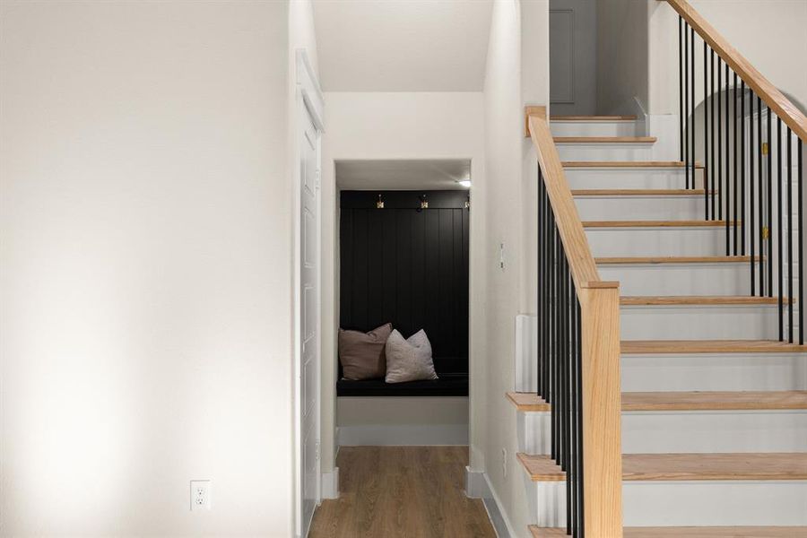 Staircase featuring wood finished floors and baseboards