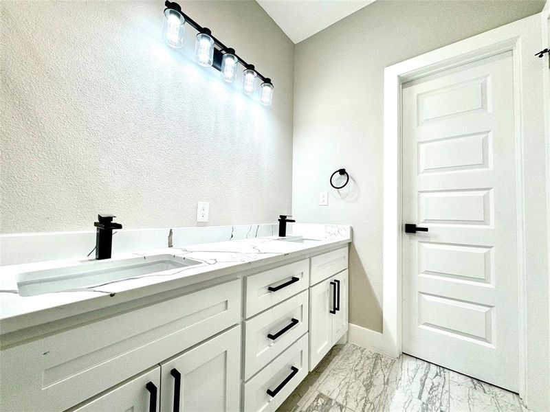 Secondary bathroom off hallway from bedrooms and entertainment space.