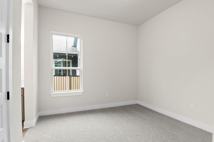 Spare room with light colored carpet and baseboards